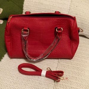 Red faux crocodile bag with detachable crossbody strap.